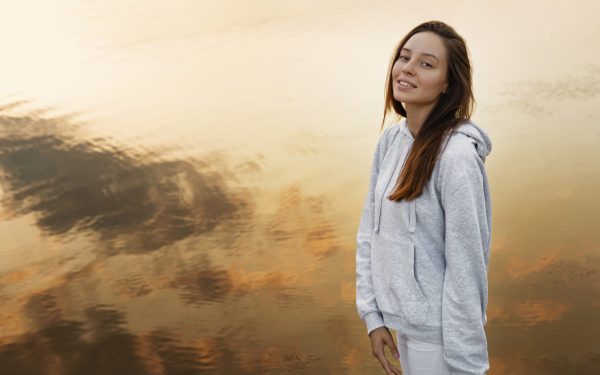 high-angle-smiley-woman-posing-outdoors
